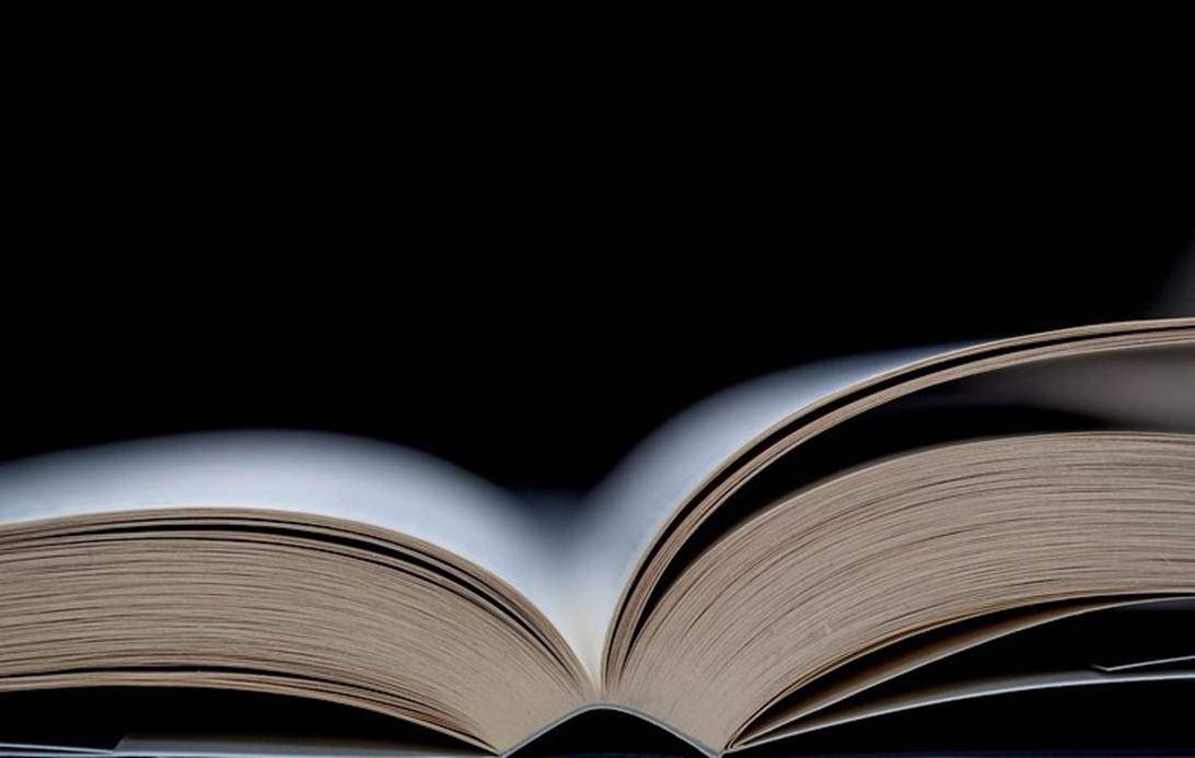 An open book with a black background
AI-generated content may be incorrect.